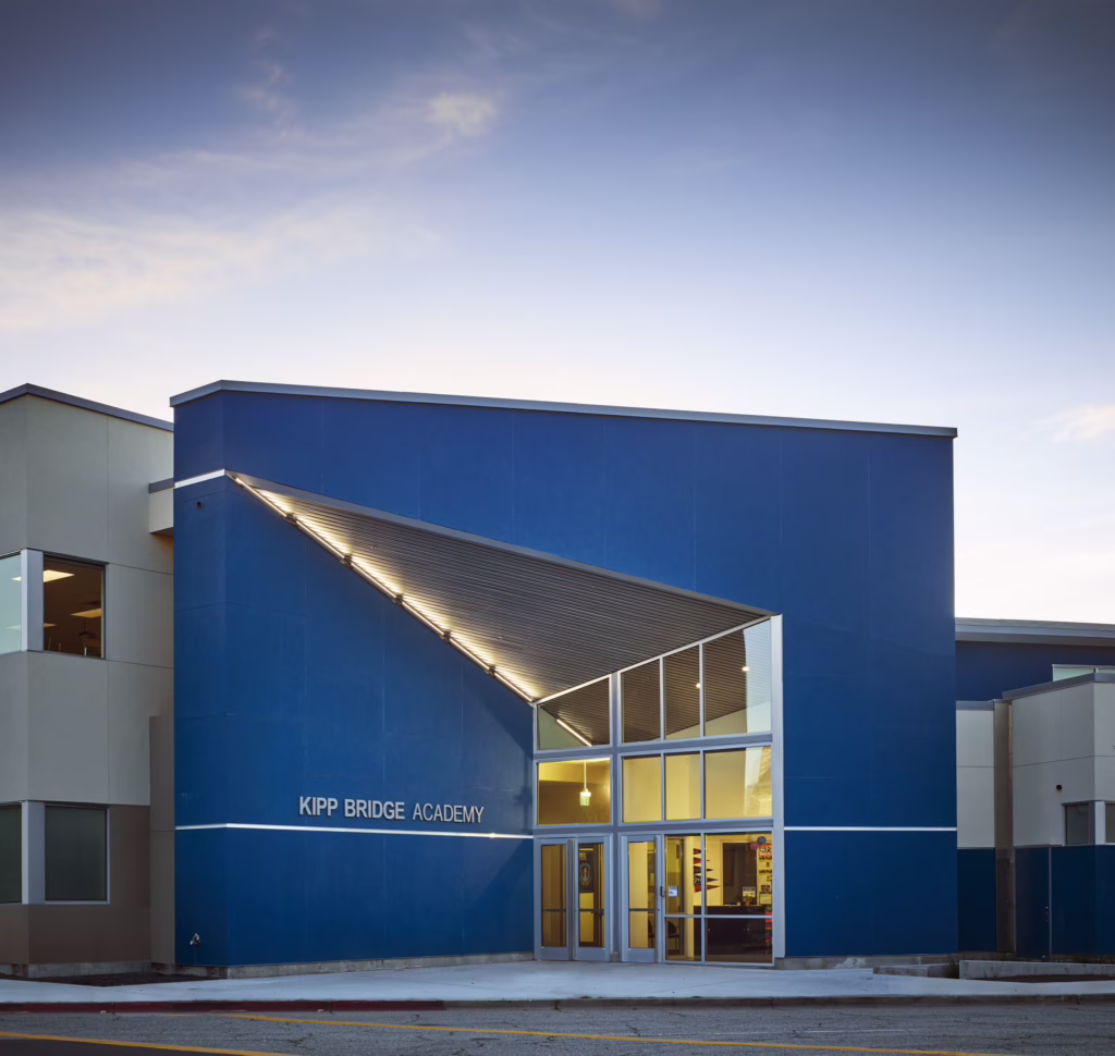 Exterior view of KIPP Bridge Academy charter school with modern blue facade, symbolizing Blueprint’s mission-aligned commitment to expanding educational access.
