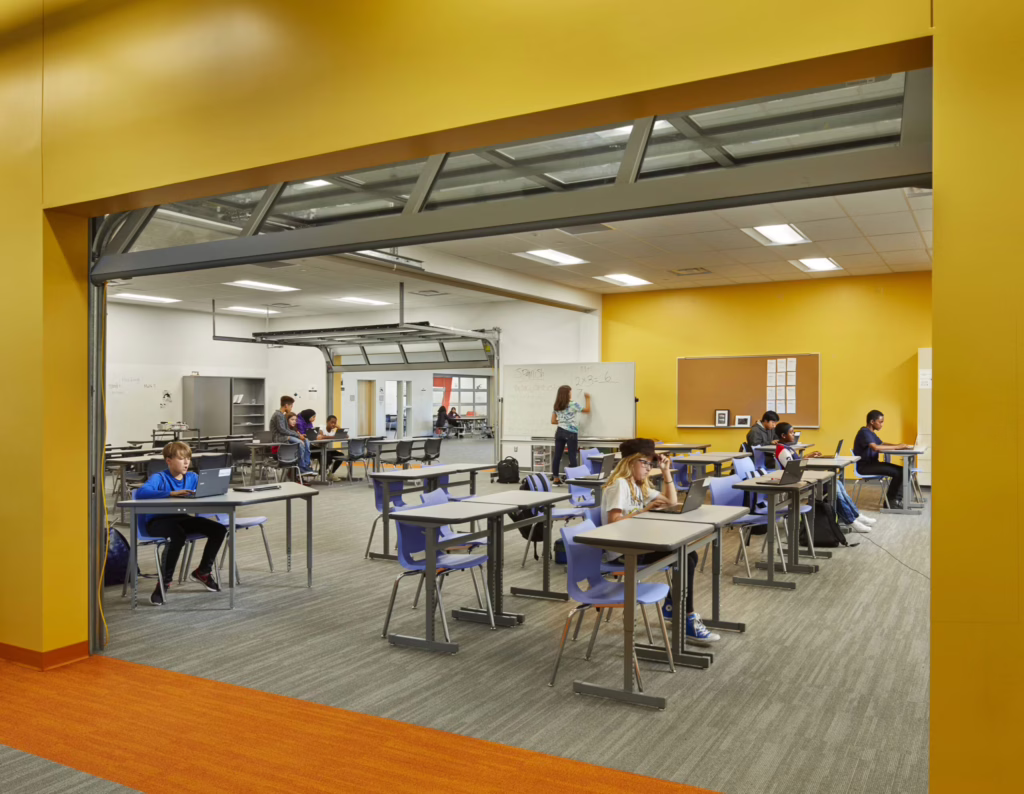 Students and teachers collaborate in a modern charter school classroom, symbolizing Blueprint’s hands-on, problem-solving partnerships with schools to deliver adaptable, student-centered facilities.